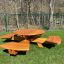 Round table & benches made of wood placed on a grassy area