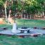 Robinia bench wooden seating around fire pit in park playground