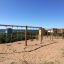 2+2 multiple swing set on a sandy playground with ocean in the background