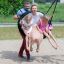 Family playing on Double Swing Robinia (BNS 90) in a playground.