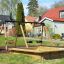 1+2 multiple swing set in a backyard playground with sandbox.