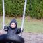 Child on a 1+2 multiple swing in the park.