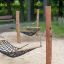 Double Hammock in outdoor park with wooden posts and netting.