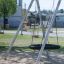 A metal swing set with a tire swing at a playground, Silver Single Swing (BNS 120).