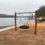 Bird Nest Single Swing Nature (BNS 120 cm) installed on a sandy lakeside beach.