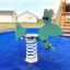 Green Rabbit rocking spring rider on a playground.