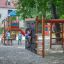 Children playing on Bird Nest Swing with Tower (BNS 120 cm) single slide in a playground.