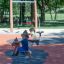 Two children playing on Pony rocking spring riders at a playground