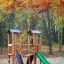 Mini Play Modern Nature outdoor wooden playground set with slide in autumn forest.