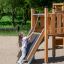Child playing on the Challenger Modern Nature single slide.