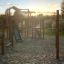 Challenger Modern Nature single slide wooden playground equipment with metal slide on sandy surface