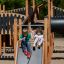 Children playing on Windsor Modern Nature castle with slide.