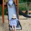 Two girls playing on a slide from Windsor Modern Nature castle with slide.