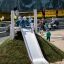 Children playing on Hill Slide h120 at a playground.