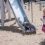 Child sliding down Hill Slide h120 in a playground.