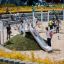 Children playing on the Hill Slide h120 in a busy playground.