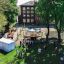 Outdoor Classroom with wooden benches, sunshades, blackboard, and plant pots in a school playground 