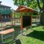 Outdoor Classroom with wooden benches, sunshades, and blackboard in a green outdoor setting