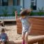 Children playing on the Ramp playground equipment outdoors.