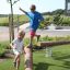 Children playing on the Ramp balance beam in a park.