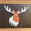 Forest Castle with slide featuring a playful moose illustration on wooden panel