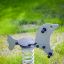 Seal rocking playground equipment on a green lawn.