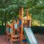 Tower with Slide wooden playground structure with climbing walls and green slide