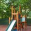 Tower with Slide wooden playground structure with climbing walls and green slide