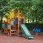 Tower with Slide wooden playground structure with climbing walls and green slide
