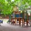 Tower with Slide wooden playground structure with climbing walls and green slide