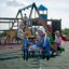 Children playing on the Car rockers at a playground.