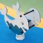 Whale rocking on colorful playground surface.