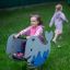 Child riding Whale rocking toy in playground.