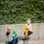 Two children playing on Double Pony rocking ride in a playground.