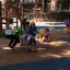 Children playing on Double Pony rocking toys at a playground.