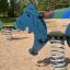 Blue Pony rocking on a playground spring.