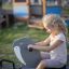 Child playing on Triple Walrus rocking toy at playground