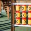 Tic Tac Toe playground game with yellow and red spinning cylinders displaying X's.