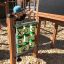 Child playing Tic Tac Toe on a playground.