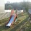 Outdoor Camel single slide playground equipment installed in a garden area.