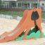 Camel single slide playground equipment in sandbox.