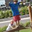 Children playing on the Balance playground equipment in a park.