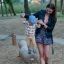 Mother helping child to balance on playground spring toy named Balance.