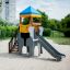 Elephant playhouse with slide on sandy playground.