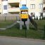 Elephant playhouse with slide in a fenced playground