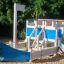 Small Ship sandbox for kids with blue sides and anchor design in playground
