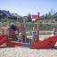 Children playing on Small Ship sandbox playground structure.