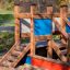 Small Ship sandbox play area for children made of wood with colorful panels.