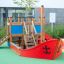 Small Ship sandbox for children with colorful and sturdy wooden structure in a playground