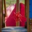 Red ship wheel on Small Ship sandbox playground equipment.